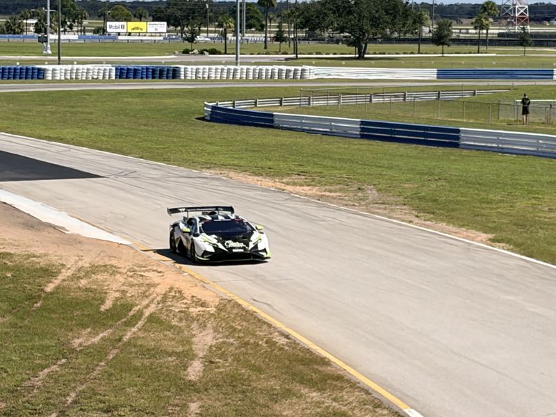 A white and black GT race car with a big rear wing turns through a corner at Sebring during the 2026 NASA Championships (photo by Darien Entwistle)